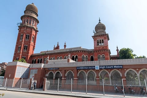 The court is an imposing red Indo-Saracenic structure 